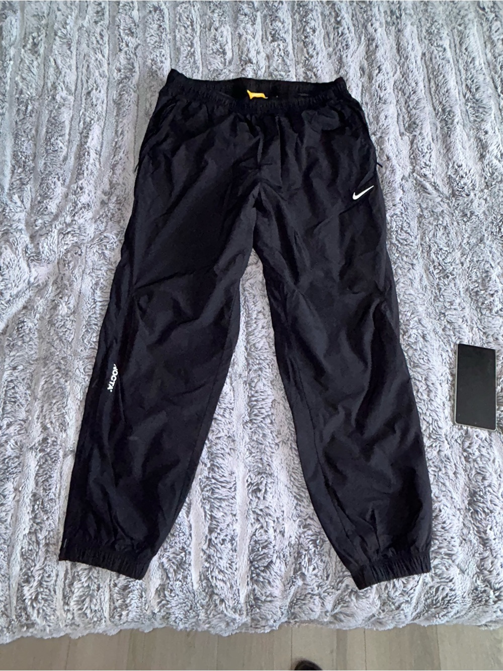 Nike Nocta Black Track Pants with Yellow Tag